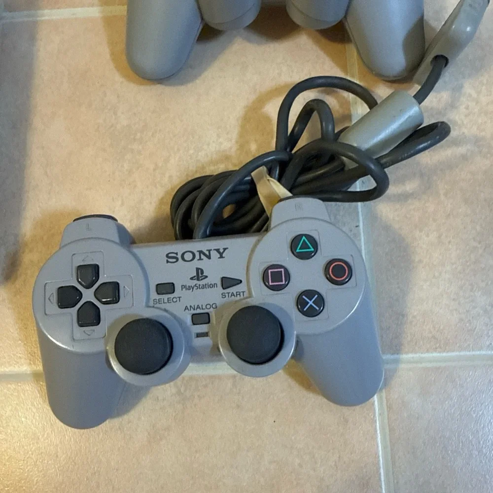 Sony Gray PlayStation Console with Two Wired Gray Controllers
